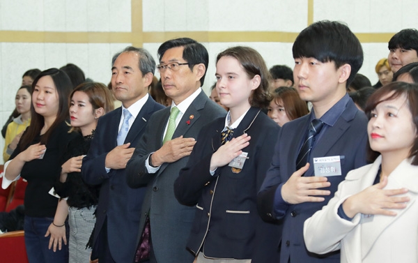 ◇한국 국적을 취득한 귀화허가자 65명이 1월 21일 서울 용산구 국립한글박물관 대강당에서 열린 제1회 대한민국 국적증서 수여식에서 국기에 대한 경례를 하고 있다.